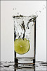 Glass of water with a lemon dropped in it.
